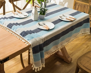 Macro detail of Nordic striped tablecloth with elegant white fringe trim and fabric texture