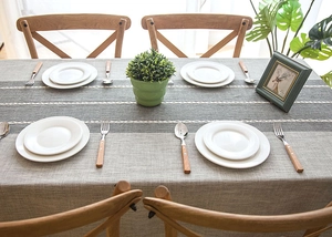Close-up of Nordic geometric jacquard tablecloth with textured stripes and white embroidery