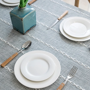 Blue linen tablecloth with embroidered geometric patterns and elegant tassel trim decoration
