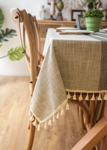 Detailed view of Nordic jacquard linen tablecloth featuring elegant stripes and beige tassels