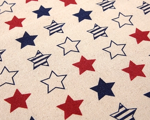 Detailed view of striped cotton linen tablecloth with red and blue star patterns