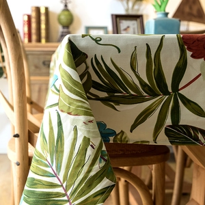Detailed texture of thick cotton canvas tablecloth with green tropical palm leaf print