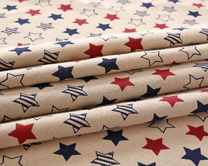 Detail of cotton-polyester tablecloth with vintage red and blue star patterns