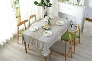 Detailed view of stripe pattern tablecloth with delicate white lace border and linen texture
