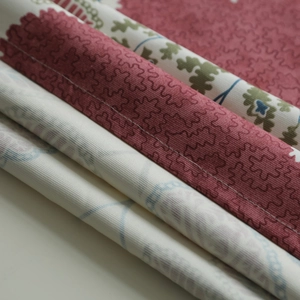 Detail of floral printed cotton tablecloth showing thick fabric layers and fine stitching