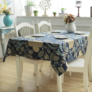 Detail of navy blue floral cotton tablecloth with vintage leaf patterns and fabric texture