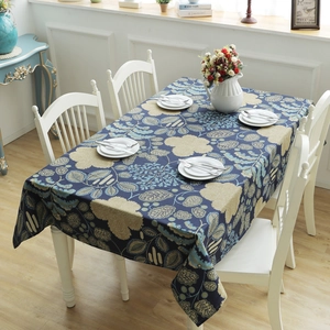 Detail of navy cotton canvas tablecloth featuring beige flower and leaf patterns