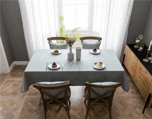 Detail of light blue-grey cotton linen tablecloth with ethnic style woven lace edges