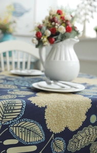 Detailed macro view of heavy cotton canvas tablecloth with abstract blue leaf pattern