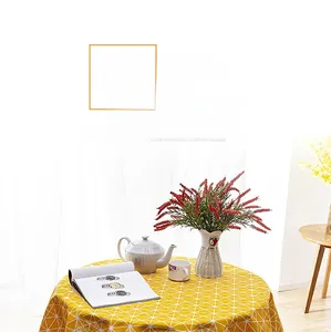 Close-up of yellow geometric grid tablecloth with decorative white tassel details
