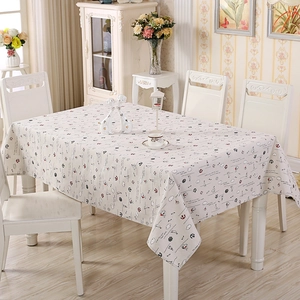 Close-up of nautical style cotton tablecloth featuring anchors and sailboats patterns