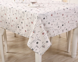 Detail of nautical table cloth featuring anchor and sailboat patterns on linen fabric