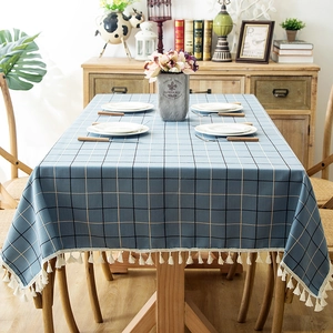 Blue checkered waterproof tablecloth with white tassel edge on rectangular dining table