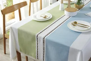 Detail of Nordic style tablecloth with geometric patchwork, leaf embroidery and lace trim