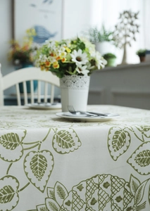 Detailed texture of thick cotton canvas tablecloth with green leaves and pineapple print