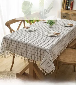 Close-up of black and white plaid tablecloth with elegant white fringe tassel details
