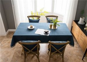 Close-up of deep blue rectangle tablecloth with exquisite woven lace edge detail