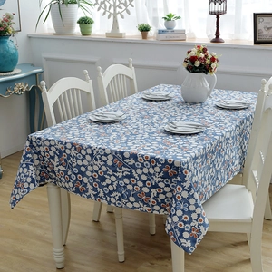 Detailed close-up of thick cotton table cloth with white floral and orange butterfly patterns