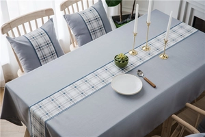 Waterproof faux linen table runner and matching cushion with blue geometric patterns
