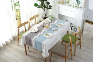 Detail of Nordic jacquard tablecloth featuring grey blue stripes and white lace trim