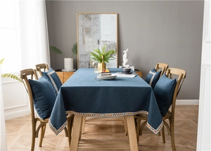 Close-up of deep blue waterproof tablecloth with colorful geometric embroidered borders