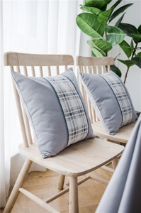 Detail of light gray faux linen cushion with blue and white checkered decorative pattern