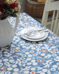 Close-up of thick cotton tablecloth with blue floral print and butterfly patterns