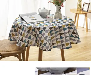 Detail of round linen-blend tablecloth featuring geometric patterns and fringe edges