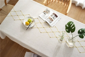 Detail of waterproof geometric embroidery and lace edge on linen tablecloth