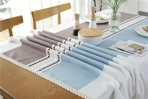 Close-up of tricolor linen table runner with embroidery and crochet lace edges
