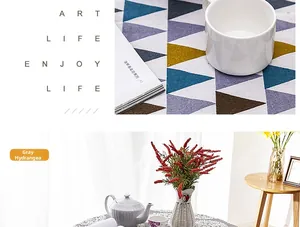 Close-up of geometric patterns and grey hydrangea floral prints on cotton linen tablecloth