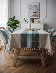 Detail of waterproof cotton linen table runner with tassels and matching pillow cover