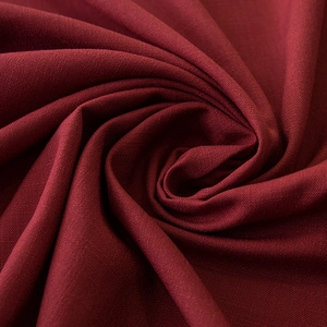 Close-up of dark red waterproof linen texture fabric with fringe details for tablecloths