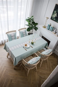Detail of mint green linen-like table runner with geometric gray checkered pattern
