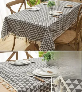 Close-up of geometric gray triangle tablecloth with high-quality white tassel fringe detail