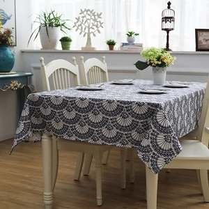 Detailed macro view of heavy cotton tablecloth featuring a blue leaf fan pattern print