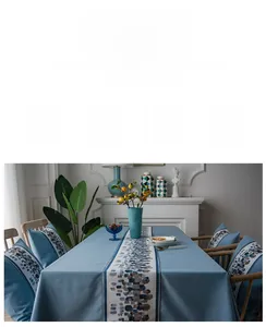 Detail of waterproof linen-textured table runner with blue ethnic floral pattern in home setting