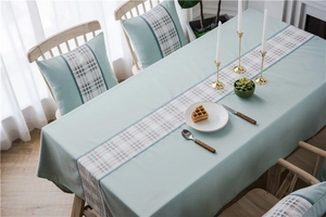 Detail of mint green waterproof faux linen tablecloth with geometric splicing and cushion