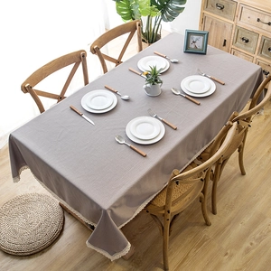 Detailed close-up of light purple linen textured tablecloth with elegant lace edges