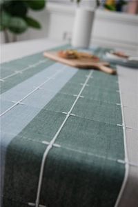 Detail of Nordic table runner showing tricolor fabric texture and white stitching details