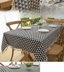 Detail of modern black and white geometric pattern tablecloth with white tassel fringe