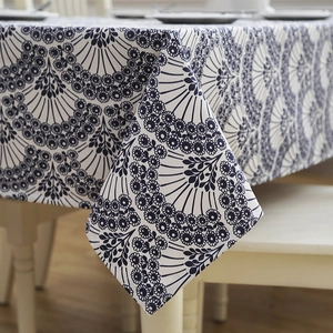 Detail shot of the elegant blue leaf pattern and natural drape of the cotton tablecloth