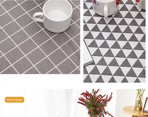 Detail of gray geometric pattern tablecloth with rustic fringe and thick cotton-linen texture