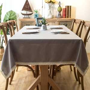 Detail of taupe rectangle tablecloth featuring elegant beige crochet lace fringe border