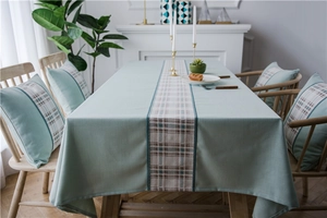Close-up of mint green faux linen table runner with geometric woven pattern details