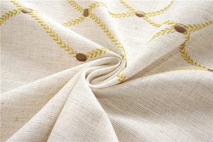 Detailed macro view of geometric embroidery on waterproof cotton linen tablecloth fabric