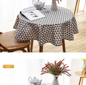 Detail of green geometric diamond pattern on linen-style tablecloth with fringe edges