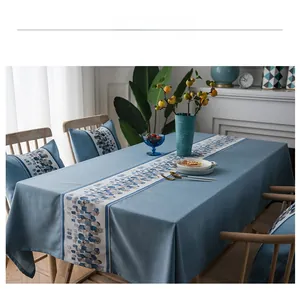 Detail of waterproof blue linen table runner with stone pattern mosaic accent strip