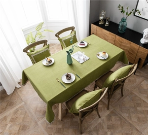 Close-up of grass green cotton blend tablecloth with wavy embroidered lace edge detail