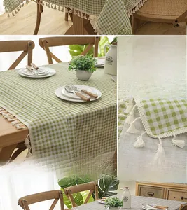 Detail of green and white plaid tablecloth featuring thick fabric and cotton tassels